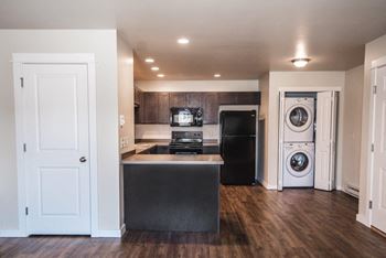 A renovated kitchen with a washer and dryer in it