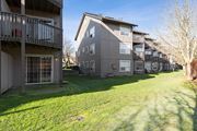 Olympia apartment for rent - Exterior of Capitol Crossing Apartments with balconies and patios lined with green grass and trees.at Capitol Crossing, Washington