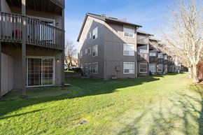 Olympia apartment for rent - Exterior of Capitol Crossing Apartments with balconies and patios lined with green grass and trees.at Capitol Crossing, Washington