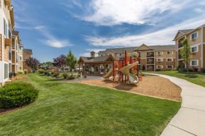 West Richland apartment for rent - Exterior of Quail Springs grounds, green grass and playground
