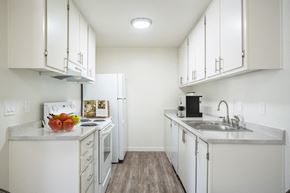 Pocatello apartment for rent - a kitchen with white cabinets and white appliances at Kirkwood Meadows, Pocatello, ID