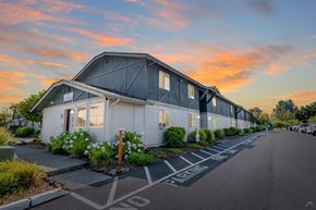 Fife apartment for rent - A building with a parking lot in front of it.