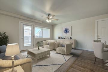 Bozeman apartment for rent - a living room with white furniture and a ceiling fan