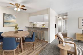 Post Falls apartment for rent - A modern dining room with a round table and blue chairs at apartments in Post Falls, ID.
