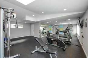 Fife apartment for rent - A gym with a row of treadmills and a weight machine.