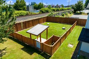 Marysville apartment for rent - a dog park with large grassy area, covered section for shade and rain protection and rocks