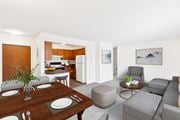 Billings apartment for rent - A modern living room with a dining table set for two. at Rock Creek in Billings, MT.
