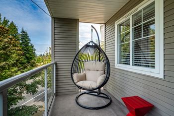 A swing chair on the porch of a home