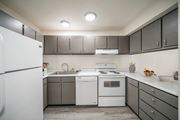Pocatello apartment for rent - a kitchen with white appliances and gray cabinets at Summit, Pocatello Idaho