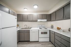 Pocatello apartment for rent - a kitchen with white appliances and gray cabinets at Summit, Pocatello Idaho