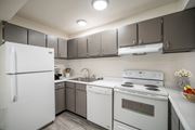 Pocatello apartment for rent - a kitchen with white appliances and gray cabinets at Summit, Pocatello, 83201
