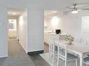 Boise apartment for rent - an open kitchen and dining room with a white table and chairs