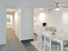 Boise apartment for rent - an open kitchen and dining room with a white table and chairs