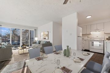 Boise apartment for rent - a living room with a table and chairs and a kitchen with a sliding glass door