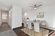 Boise apartment for rent - a dining room with a table and chairs and a ceiling fan