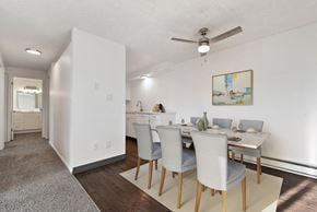 Boise apartment for rent - a dining room with a table and chairs and a ceiling fan
