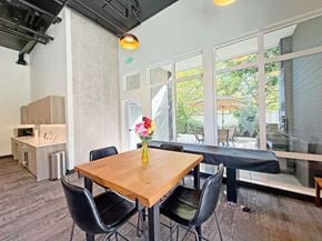 University Place apartment for rent - A dining room with a wooden table and chairs at The Duo Apartments in University Place, WA.