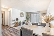 Kennewick apartment for rent - A dining room with a white table and grey chairs at Wildflower Apartments in Kennewick, WA..