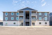 East Wenatchee apartment for rent - Exterior image of building. Blue, grey, and white siding and outdoor access to units. at Altitude, East Wenatchee