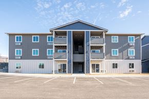 East Wenatchee apartment for rent - Exterior image of building. Blue, grey, and white siding and outdoor access to units. at Altitude, East Wenatchee