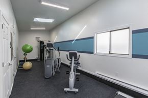 Moses Lake apartment for rent - Community gym with window and exercise balls, stationary bike, elliptical, cable machine and free weights.at The Lakes Apartments, Moses Lake, WA 98837