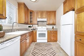 San Diego apartment for rent - Large U-shaped kitchen with granite countertops, dishwasher, sink, stove, oven and fridge at Pacific Sands, San Diego, California