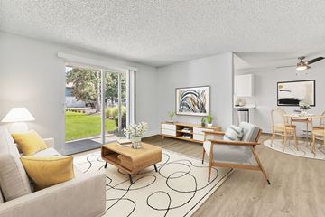 Fife apartment for rent - A living room with a grey couch, yellow pillows, a wooden coffee table, and a painting on the wall.