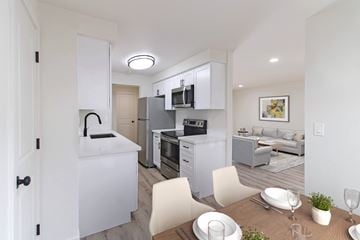 Redmond apartment for rent - A modern kitchen with white cabinets and appliances, a dining table set with plates and glasses, and a living room with a couch and a painting on the wall.