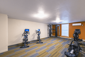 Wenatchee apartment for rent - Fitness center with one window, stationary bikes, cable machine and rowing machine..at Park View Apartments, Wenatchee