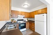 Billings apartment for rent - A kitchen with wooden cabinets and a white refrigerator.