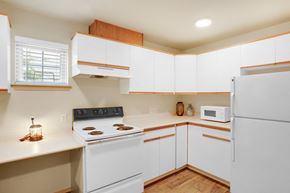 Bellingham apartment for rent - a kitchen with white cabinets and a white stove and white refrigerator at Sky Vue, Bellingham, 98229