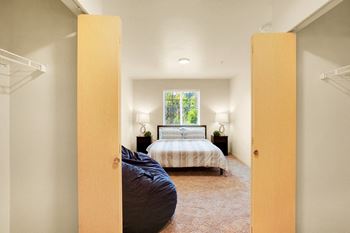 A bedroom with a bed and a window
