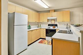 Everett apartment for rent - Kitchen with light wood cabinets at Sunrise Lane Apartments Everett WA