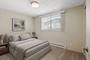Moses Lake apartment for rent - Carpeted bedroom with queen bed and large window with blinds for natural light at the Lakes Apartments in Moses Lake
