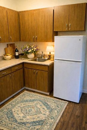 Redding apartment for rent - Kitchen with wooden cabinets at River Commons Senior Living, Redding, CA, 96002