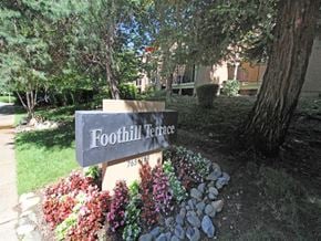 Auburn apartment for rent - Foothill Terrace sign with flowers around it