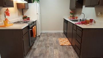 Fair Oaks apartment for rent - A kitchen with brown cabinets and a white refrigerator.