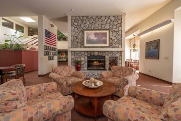 Grass Valley apartment for rent - a living room with couches a table and a fireplace