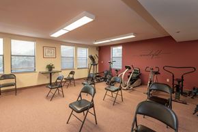 Grass Valley apartment for rent - Fitness room with exercise equipment and chairs at Hilltop Commons Senior Living Apartments, Grass Valley, CA 95945