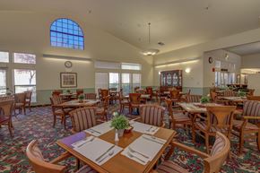 Grass Valley apartment for rent - Community dining room with table settings and natural light at Hilltop Commons Senior Living Apartments, Grass Valley