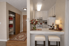 Roseville apartment for rent - Linen closet and breakfast bar with two stools at Roseville Commons Senior Living Apartments, California