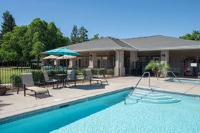 Atwater apartment for rent - Pool area with spa and clubhouse building at Castle Vista Senior Duplex Community Apartments, Atwater