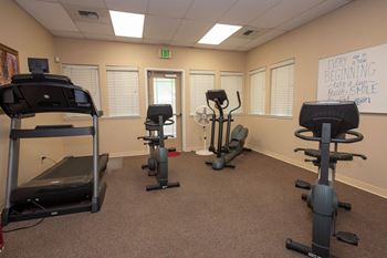 Fitness room with treadmill and stationary bikes