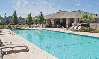 Outdoor swimming pool with lounge chairs and clubhouse