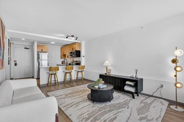 Washington apartment for rent - A modern living room with a white sofa and a round coffee table.