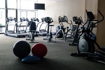 A gym with treadmills and exercise balls