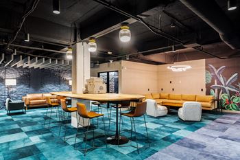 A large room with a table and chairs in a lobby