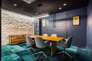 A conference room with a wooden table and chairs