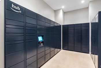 A row of navy blue lockers in a room with a computer in the middle