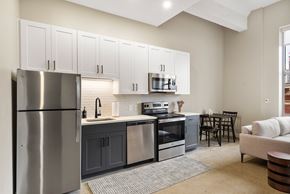 Cincinnati apartment for rent - a kitchen with stainless steel appliances and white cabinets at Textile Apartments, Cincinnati, OH
